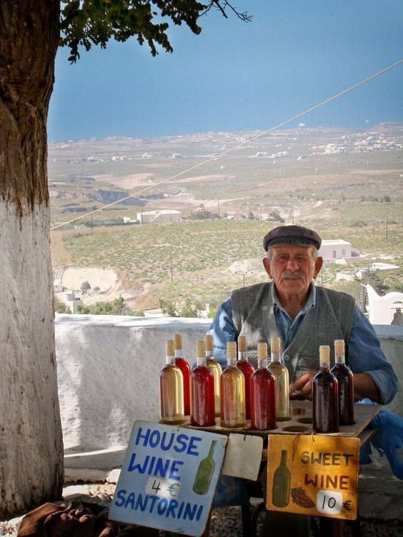 a man sitting under a tree selling wine