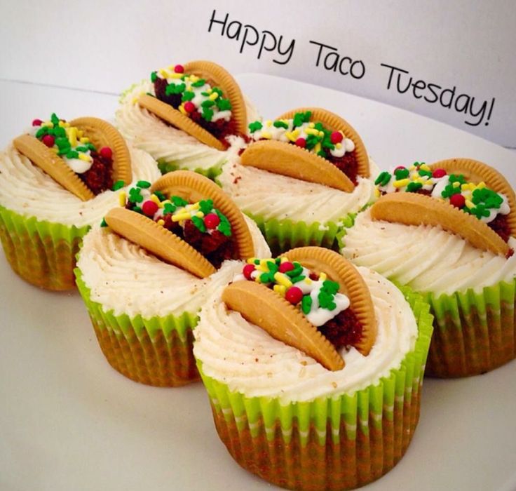 six cupcakes with frosting and decorations on them sitting on a white plate