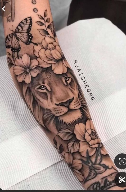 a lion with flowers and butterflies on his arm