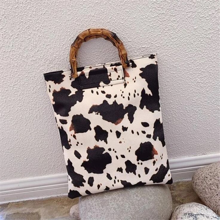 Cow Print Mini Tote Bag Faux Leather Handbag 14' X 12" Cow Print Shopper Tote Bag Faux Leather The Cow Print Shopper Style Tote Bag Is A Multi-Functional Tote Handbag. The Shopper Bag Is A Fantastic Handbag For Style And Functionality, Whether You Need To Carry A Change Of Shoes, Or Want To Have Easy Access To Your Keys, Your Makeup, Carry Your Laptop, You Name It The Brown Cow Print Pattern On A Beige Background Looks Every Elegant. Dimensions: 14" Tall X 12" Wide. Lined Inside One Main Zippere Rectangular Cow Print Travel Bag, Cow Print Leather Bag For Daily Use, Black Bag With Cow Print For Everyday Use, Trendy Cow Print Bags For Everyday Use, Leather Cow Print Bag For Everyday Use, Casual Everyday Bag With Cow Print, Casual Cow Print Bags For Daily Use, Brown Cow Print Bag For Everyday Use, Brown Cow Print Bag