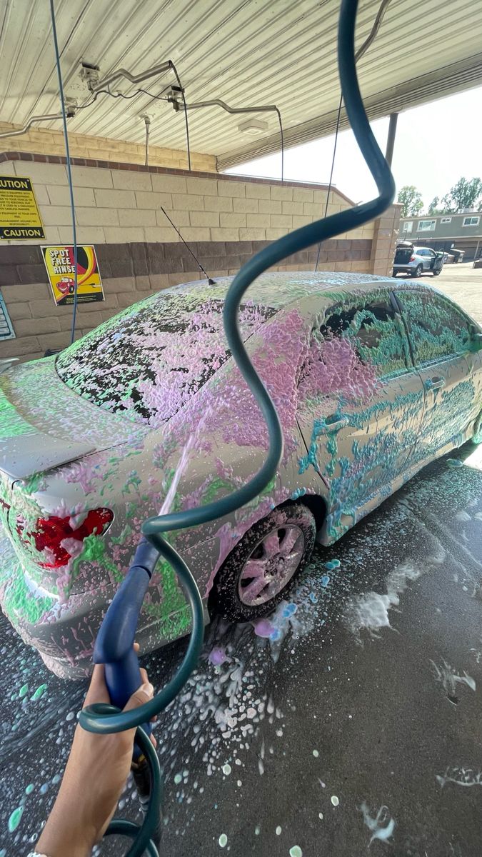 someone is painting a car with spray paint