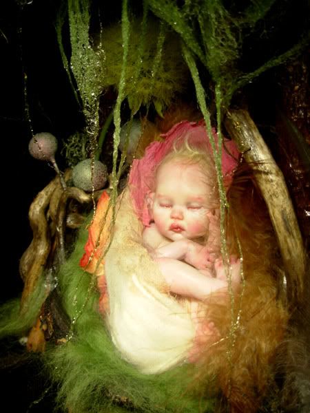 a baby is sleeping in a basket with moss