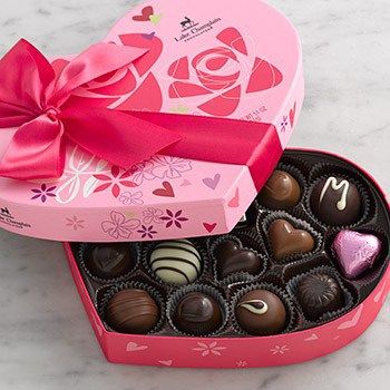 a heart shaped box filled with assorted chocolates