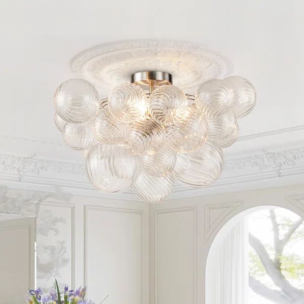 a chandelier hanging from the ceiling in a white room