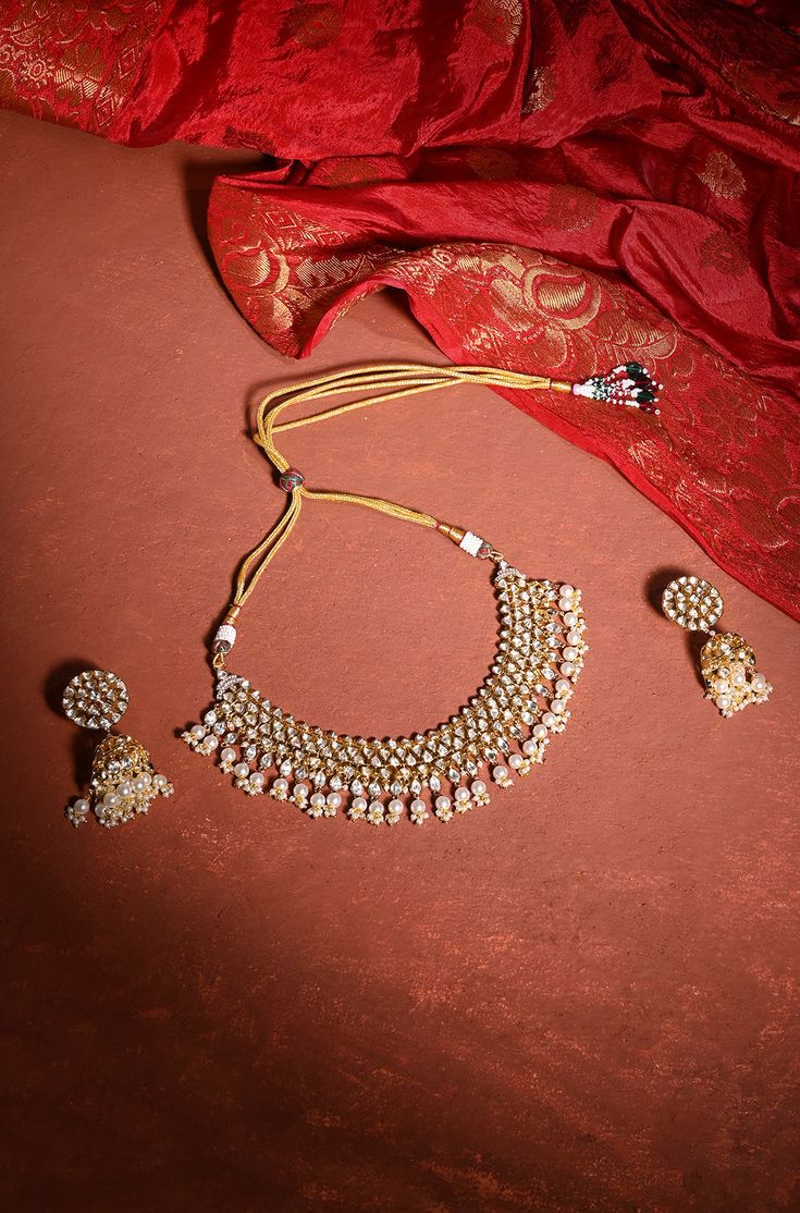 This captivating kundan set exudes both beauty and grandeur, featuring an intricate design that combines elegance with dramatic flair. Its striking 22K gold-plated mixed metal base is embellished with stunning kundan stones, creating a unique and eye-catching look. The set is complete with matching jhumkis that add a touch of opulence and sophistication. Ideal for special occasions, this set is sure to make a memorable statement, effortlessly blending tradition with contemporary glamour. Finish: Hand Jewelry Rings, Chain Braid, Artificial Jewelry, Jewelry Indian, Hand Jewelry, Glamour Fashion, Anklet Jewelry, Charm Gift, Intricate Design