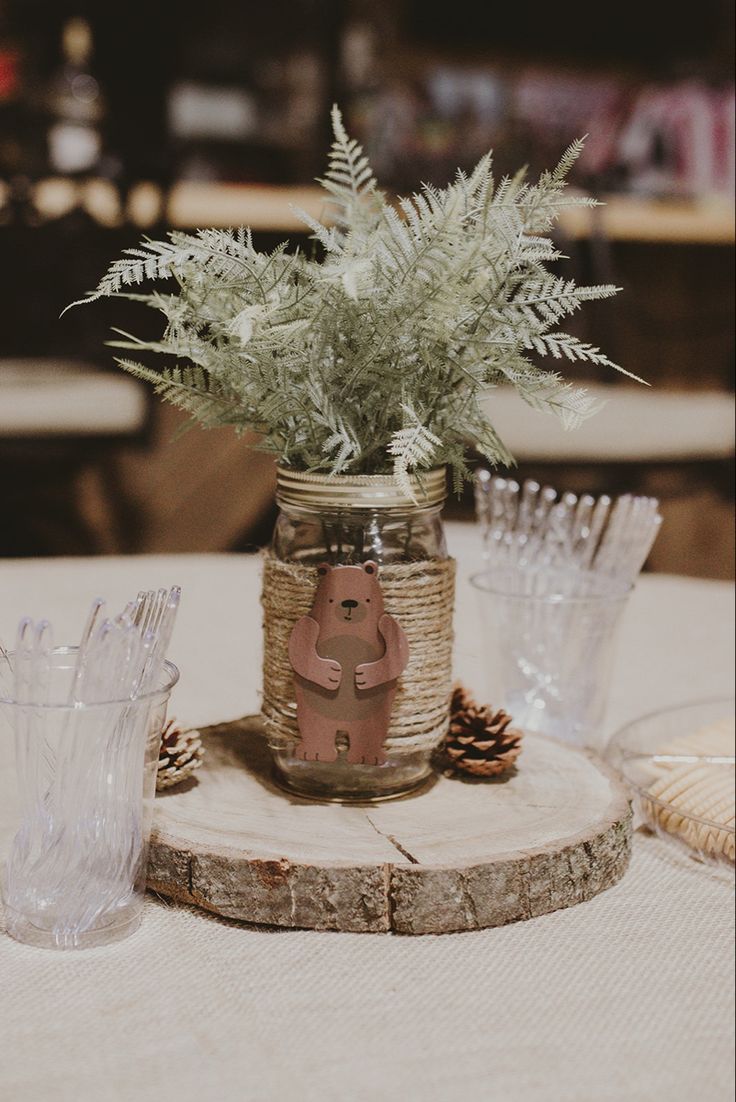 there is a plant in a mason jar on the table