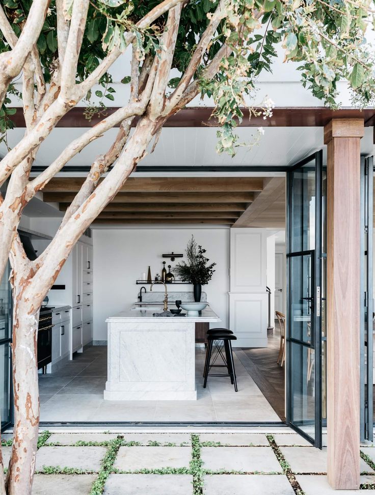 an open kitchen and dining area with white walls