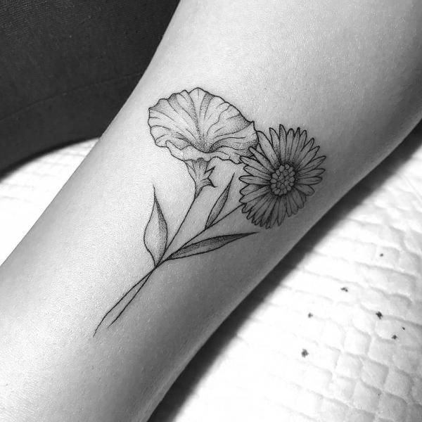 a black and white photo of a flower on the arm