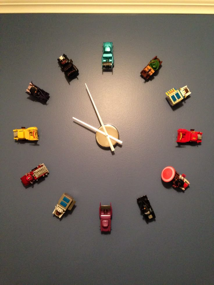 a clock made out of toy cars on a wall