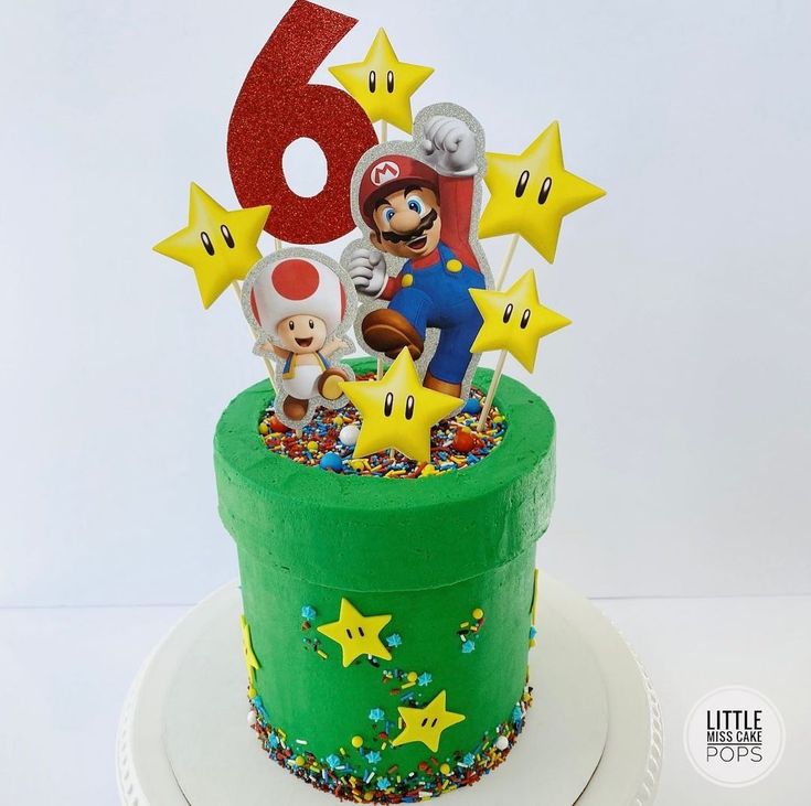 there is a green cake decorated with stars and mario on it's top that says 6th birthday