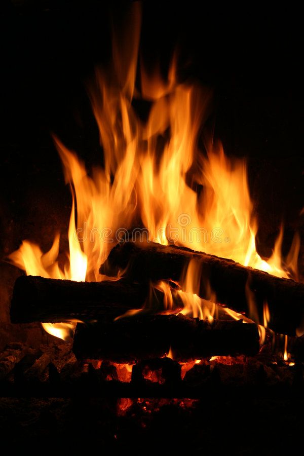 a fire burning in the fireplace with bright flames