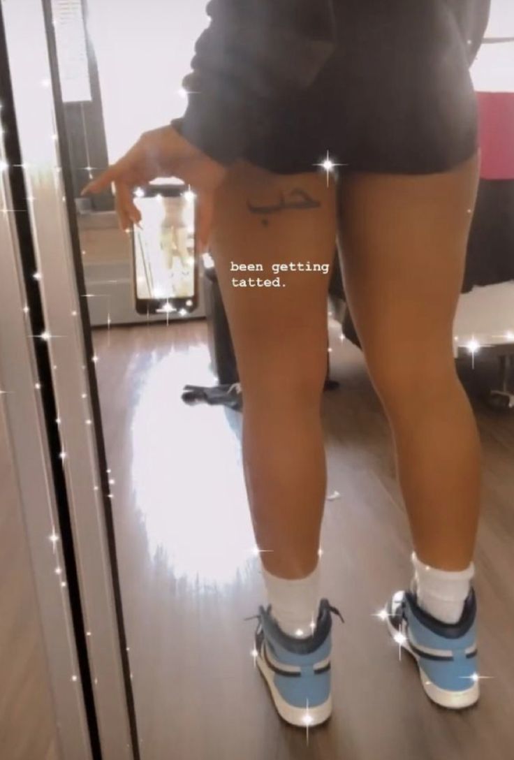 a woman in shorts and sneakers is standing on the floor