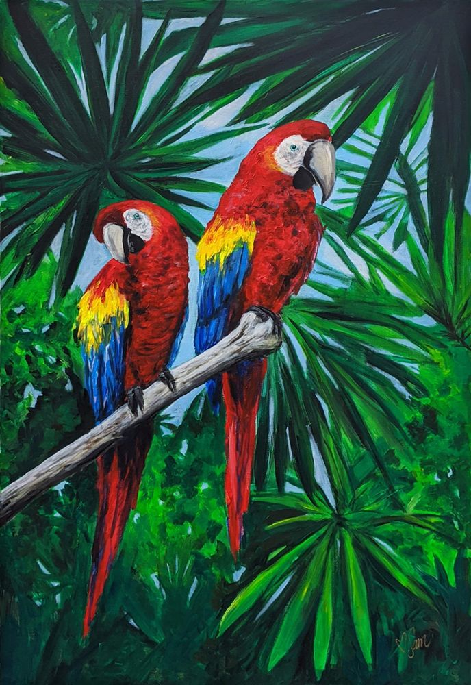 two red and yellow parrots perched on a branch in front of palm trees with green leaves