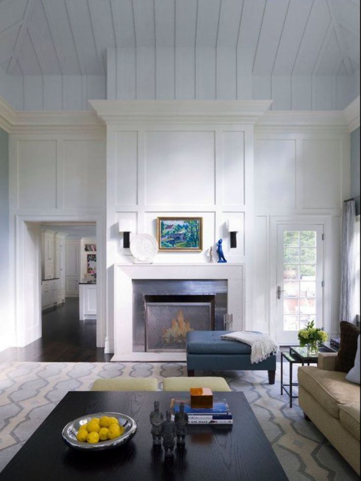 a living room filled with furniture and a fire place in the middle of a room