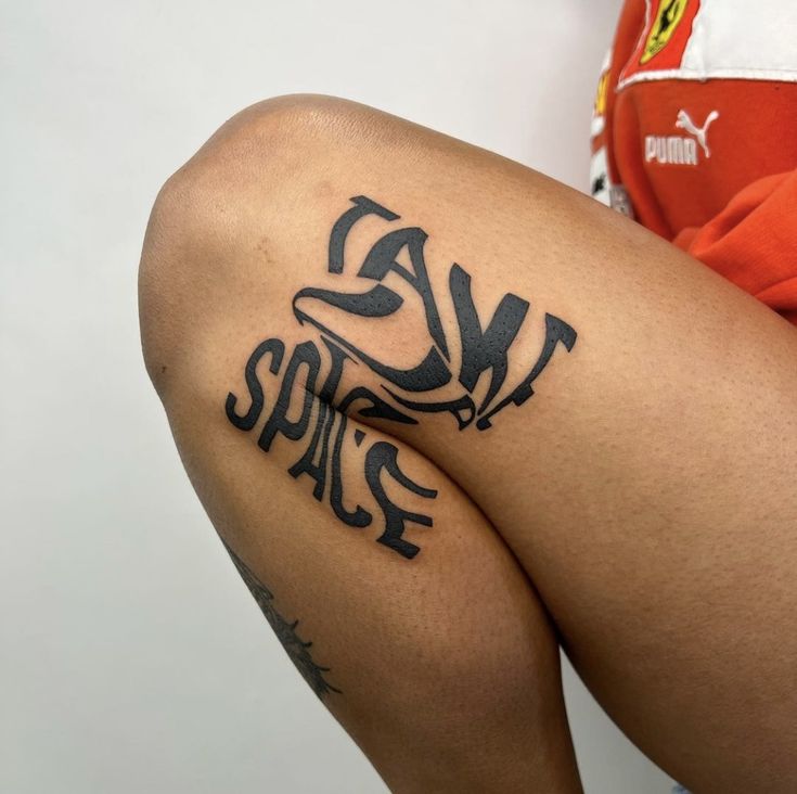 a woman's legs with tattoos on them and the words space written in black ink