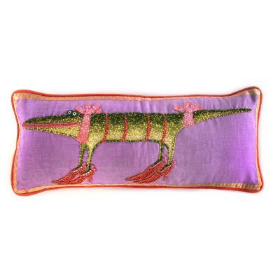 a purple pillow with an image of a dinosaur on the front and bottom, along with red trimmings