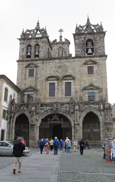 people are standing in front of an old church