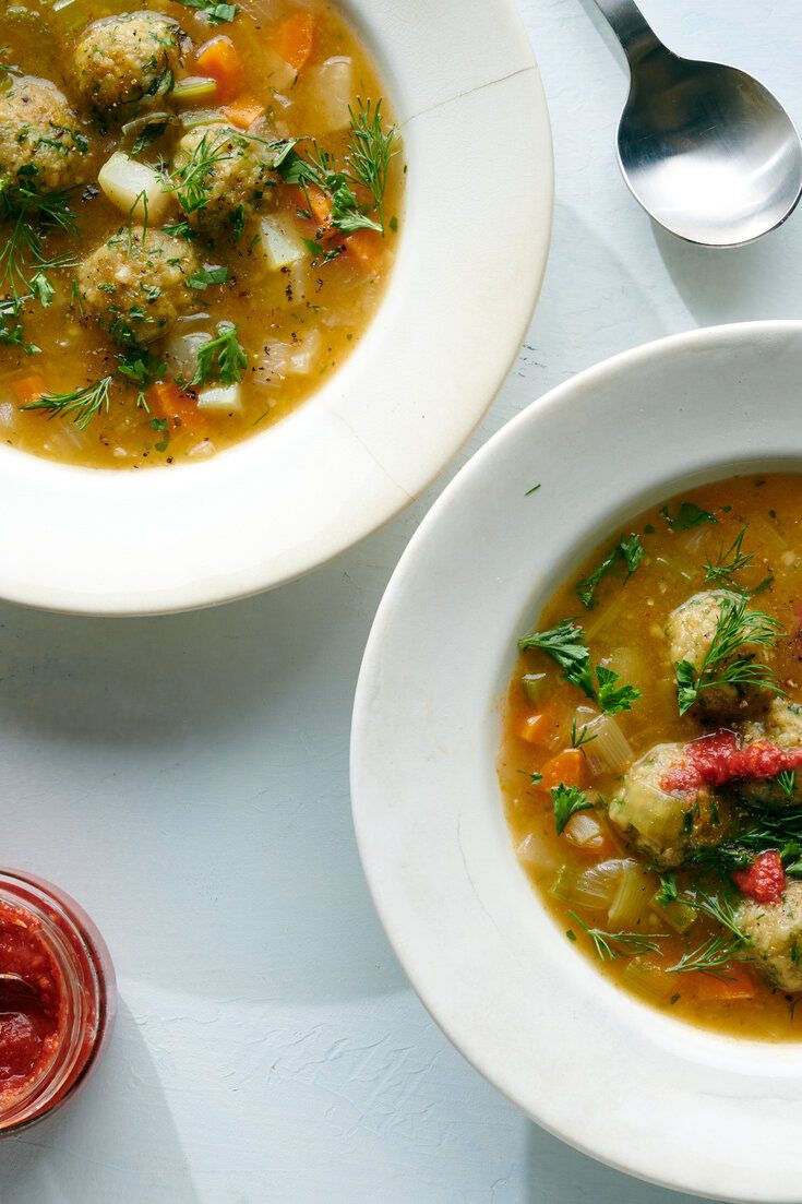 two bowls of soup with meatballs and vegetables