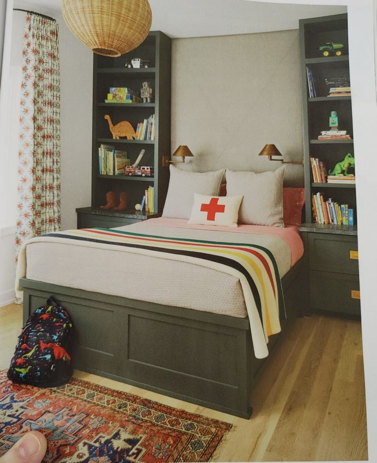 a bed room with a neatly made bed and a book shelf next to the bed