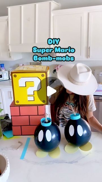 Trish 💕 Beautiful Lifestyle Blogger on Instagram: "DIY Super Mario Bomb-omb’s 💣 ⭐️ Comment “bomb” for the links! I thought it would be fun to create a 3D birthday backdrop for my Husband’s birthday 🥳 And when I saw these little bombs, I knew I had to make them! I used black balloons  Card stock paper, tape, and rope! I thought they turned out so cute! And they’re super easy to make! Tag me if you make your own! I’d love to see them! 😃 💣⭐️  . . #supermario #mario #mariobros #supermariobros #bomb #diy #diycrafts #diyhomedecor #diyprojects #diycraft #diyproject #diyparty #diypartydecor #party #partydecorations #partydecor #partyideas #partydecorations #partytime #partyinspiration #partyballoons #balloons #partyplanner #partydetails #partydecoration #partyplanning #makeitwithmichaels #hob Super Mario Brothers Diy Decorations, Mario Banana Peel Diy, Diy Super Mario Backdrop, Mario Birthday Party Dollar Tree, Mario Backdrop Birthday Party Ideas, Diy Mario Banana Peel, Mario Bros Birthday Party Decoration, Mario Party Balloons, Mario Party Themed Food