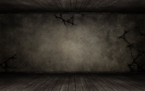 an empty room with wood floors and concrete walls is shown in this dark scene photo