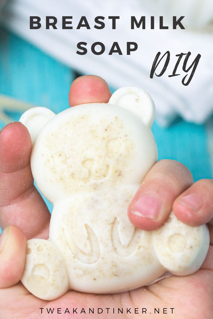 a hand holding a white bear soap bar with the words breast milk soap on it