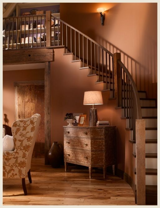 a living room filled with furniture and a stair case