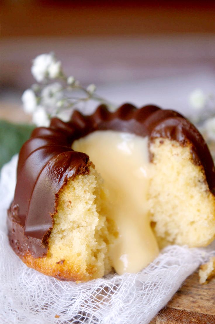 a half eaten bundt cake with white icing and chocolate drizzled on top