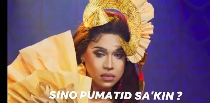 a woman in an elaborate headdress holding a fan with the words sino pumatid sa kin?