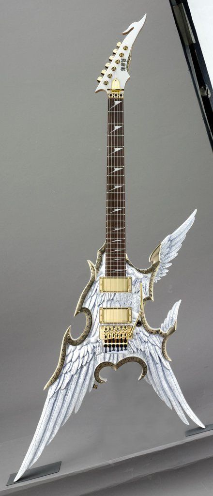 a guitar with wings on top of it