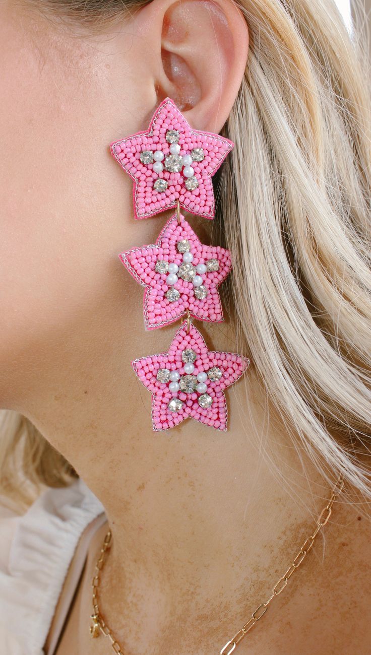 Add some sparkle and shine to your day with these cute pink beaded earrings! Featuring a star shape and tons of shimmer, dollys world earrings are sure to make you star of the show. And the best part? They won't break the bank—stellar style for a stellar price! NOT available for in store credit or exchange (see policy for more info) filter used to brighten color Cute Pink Beaded Dangle Earrings, Cute Pink Dangle Beaded Earrings, Pink Star Earrings For Party, Pink Star-shaped Party Earrings, Pink Star Charm Dangle Earrings, Pink Star Charm Jewelry, Pink Dangle Earrings With Star Charm, Pink Star-shaped Jewelry For Party, Star-shaped Beaded Jewelry For Party