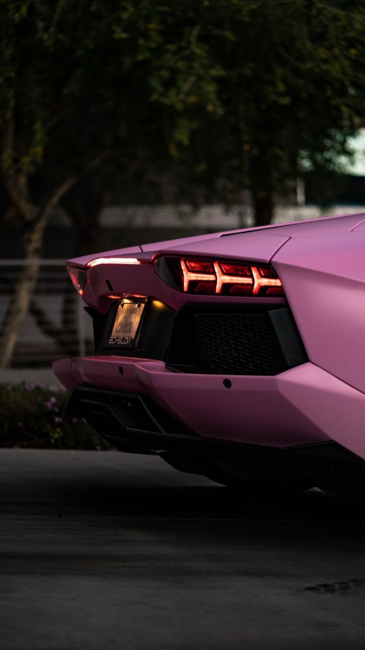 the rear end of a pink sports car