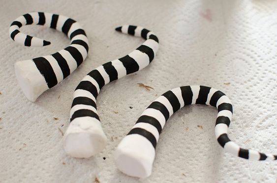 two black and white striped sticks laying on top of a table