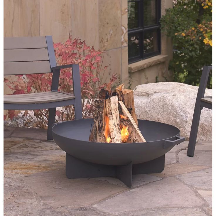 a fire pit sitting on top of a stone patio