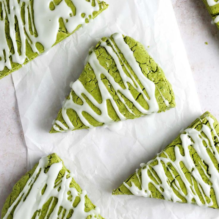 green tea cookies with white icing on parchment paper