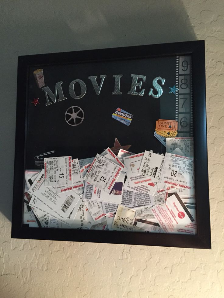 there is a black frame with movies written on it and lots of tickets scattered around