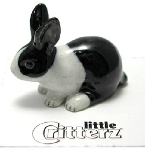 a black and white rabbit figurine sitting on top of a table