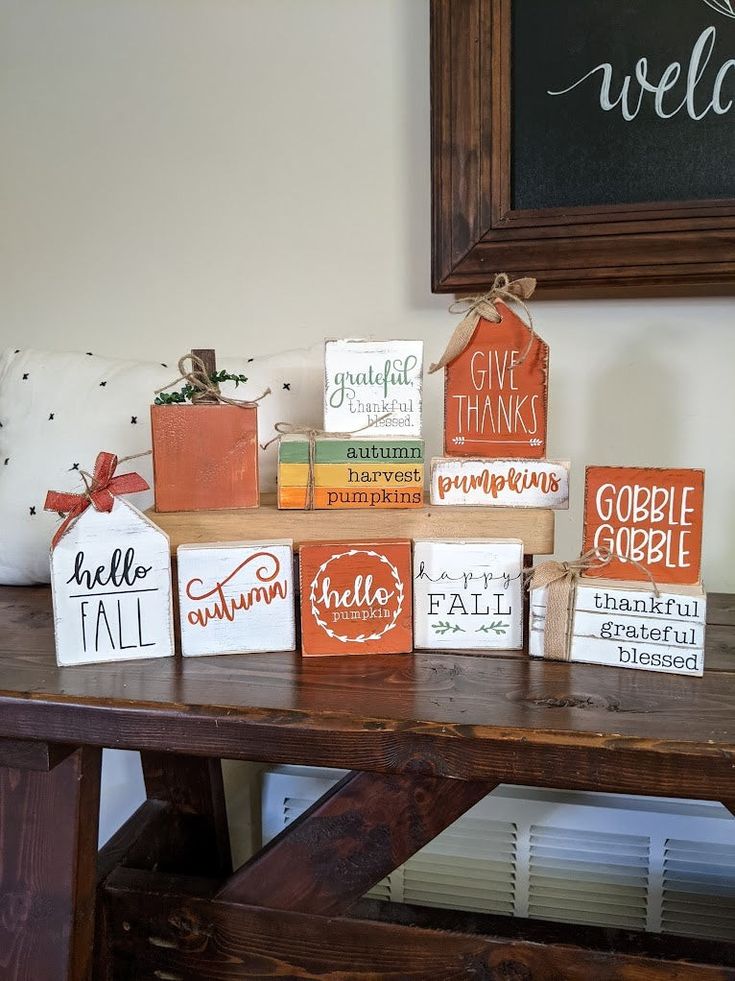 several small boxes are sitting on a wooden table in front of a chalkboard sign