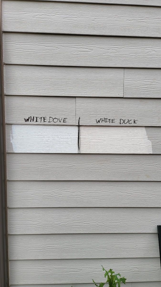 two pieces of paper taped to the side of a house