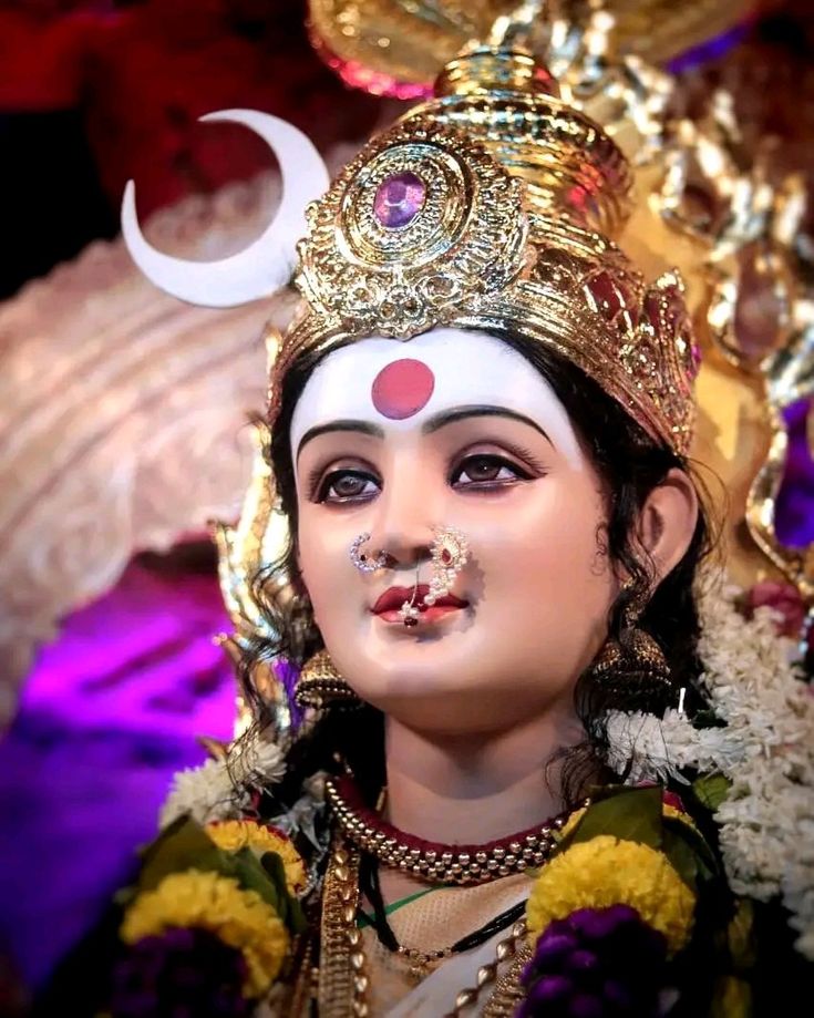 a close up of a statue of a person wearing a headdress and makeup