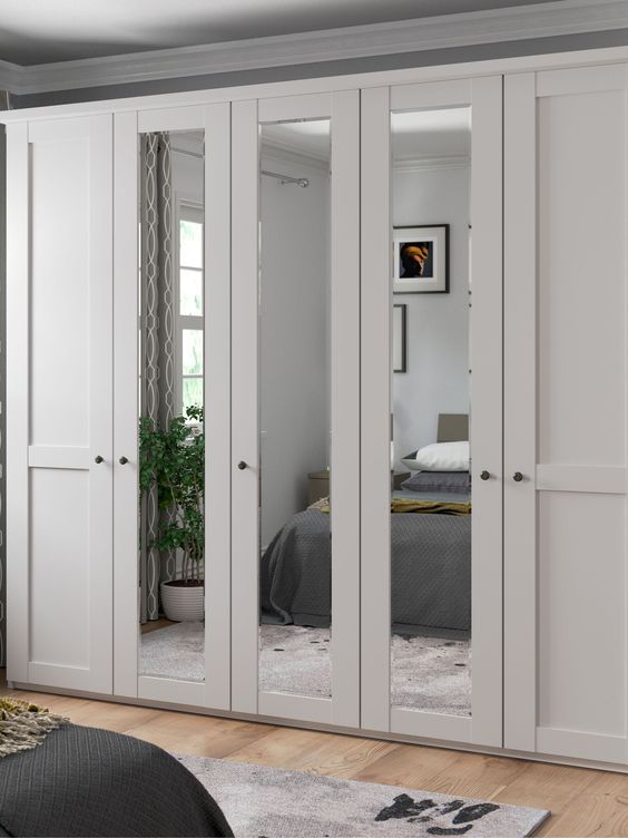 an image of a bedroom setting with mirrored closet doors