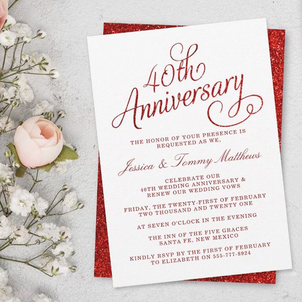 a red and white wedding anniversary card on top of a table next to some flowers