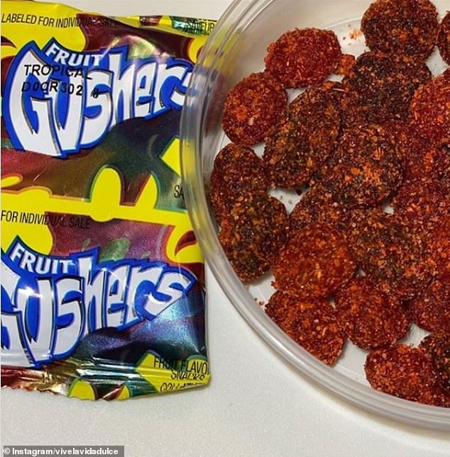 a bowl filled with fruit gummies next to a bag of gummy bears