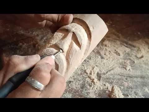 a man is carving a piece of wood