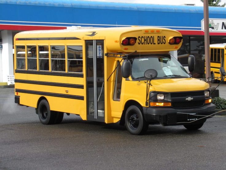 a yellow school bus parked in front of a building