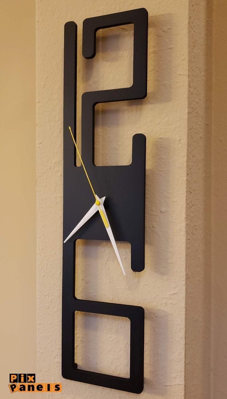 a clock made to look like an abstract piece of art with the letter e on it