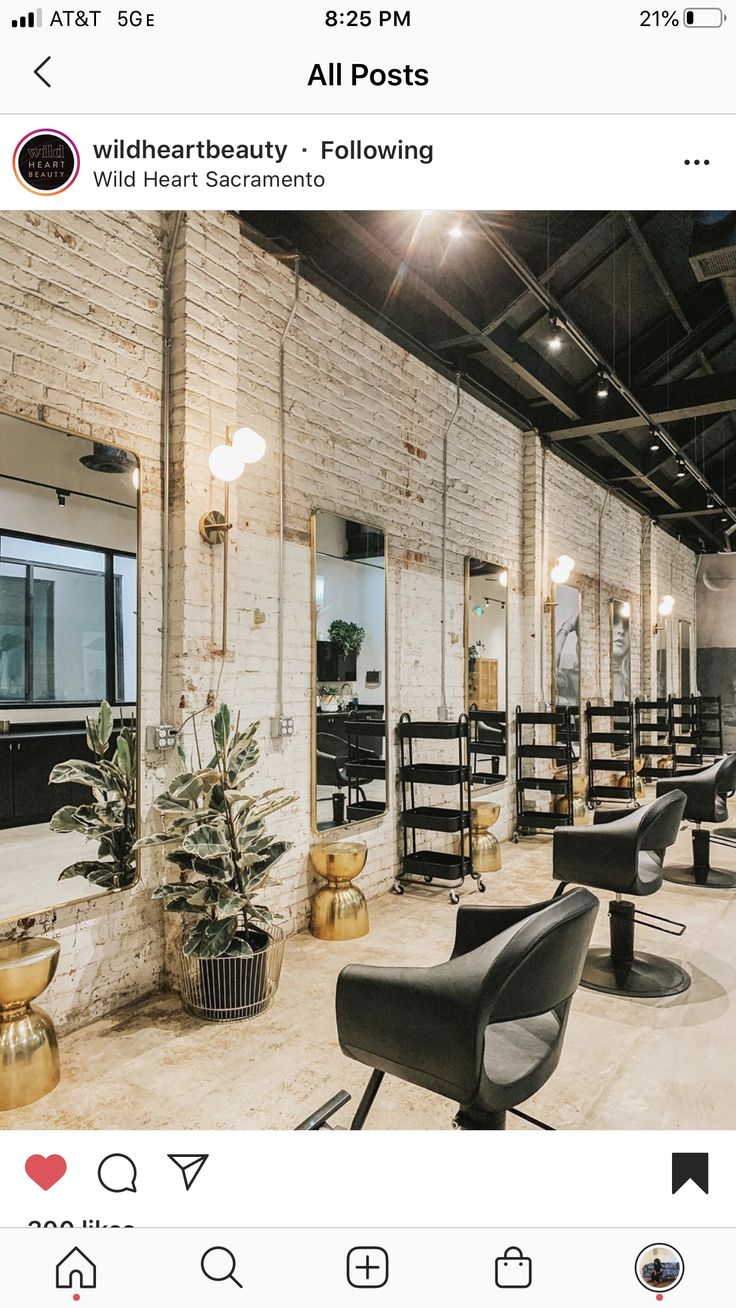 a hair salon with lots of chairs and mirrors on the wall, all in black