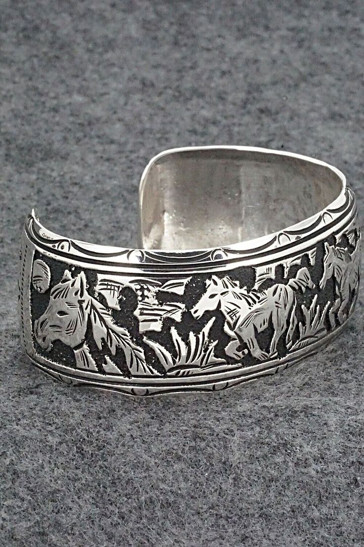 This expertly crafted sterling silver bracelet featuring horses was made by Navajo silversmith Richard Singer. The back is signed R Singer and stamped .925.Size: 5 5/8" (will fit up to a 6 3/4" wrist)Gap: 1 1/8"Width: 1"Free shipping on all orders! We ship with USPS and always include tracking. All orders ship within a day of payment.Returns are accepted up to 30 days after you receive your order. Just send us a message. Our shop offers cash back or store credit. The item must be returned in new Southwestern Engraved Silver Cuff Bracelet, Southwestern Silver Cuff Bracelet With Inlay, Southwestern Style Nickel-free Bangle, Nickel-free Southwestern Bangle Cuff Bracelet, Southwestern Silver Hand-strung Bracelets, Sterling Silver Bracelet, Native American Jewelry, Free Jewelry, Sterling Silver Bracelets