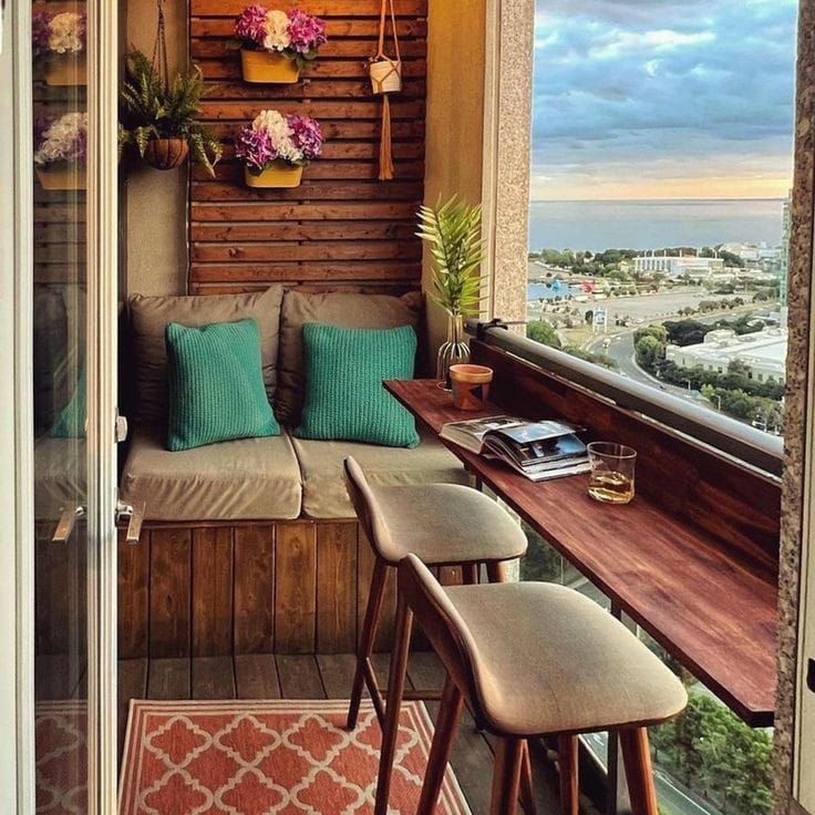 the balcony is decorated with flowers and potted plants on wooden shelves, along with two chairs