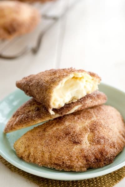 two pastries on a blue plate sitting on a table